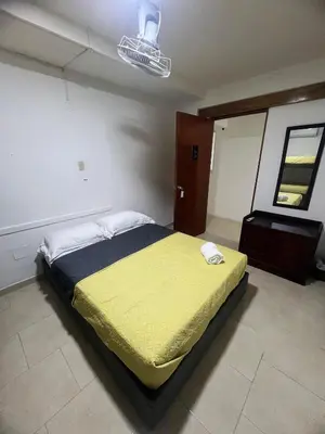 a bedroom with a bed with a yellow blanket at Casa Crespo Caribe Cartagena in Cartagena de Indias