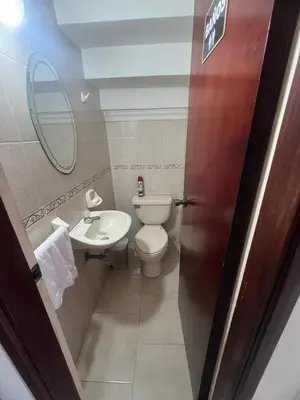 a bathroom with a toilet and a sink and a mirror at Casa Crespo Caribe Cartagena in Cartagena de Indias