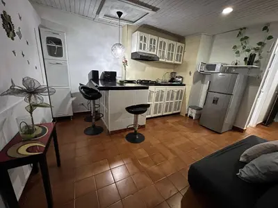 a small kitchen with a counter and a stove top oven at Apartamento turístico cerca al mar in Cartagena de Indias