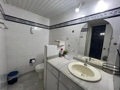 a bathroom with a sink and a toilet and a mirror at Apartamento turístico cerca al mar in Cartagena de Indias