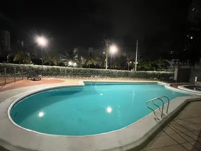 a large swimming pool at night with lights at Apartamento turístico cerca al mar in Cartagena de Indias