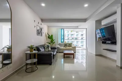 a living room with a couch and a tv at Morros Malibu Beach - Con vista al mar in Cartagena de Indias
