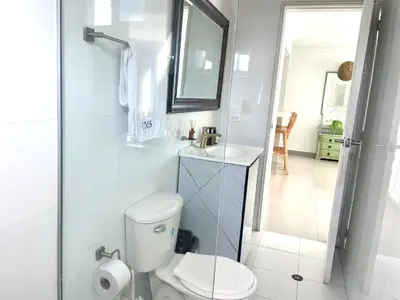 a bathroom with a toilet and a sink and a mirror at Ocean view apartment in a great location in Cartagena de Indias