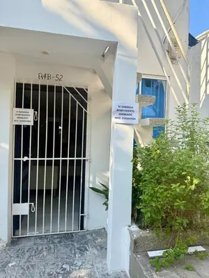 a gate in front of a house with signs on it at First floor house in Barranquilla