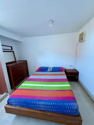 a bedroom with a bed with a colorful blanket on it at First floor house in Barranquilla