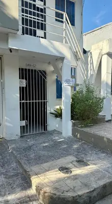 an entrance to a white building with a gate at First floor house in Barranquilla