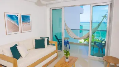 a living room with a couch and a view of the ocean at Magico Apartamento Frente al Mar 3 Habitaciones AR53 in Coveñas