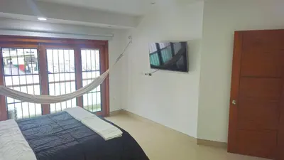 a bedroom with a bed with a hammock in it at Guest House with AC, close to Historical Centre 1 in Cartagena de Indias