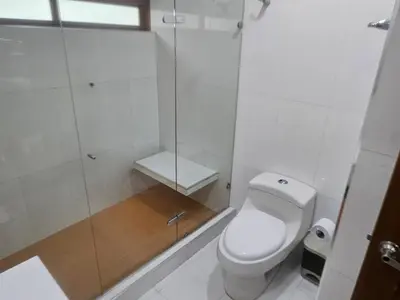 a bathroom with a toilet and a glass shower at Guest house with AC close to Historical Centre 2 in Cartagena de Indias