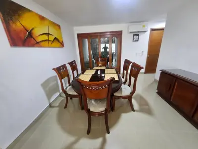 a dining room table with chairs and a painting on the wall at Guest house with AC close to Historical Centre 2 in Cartagena de Indias