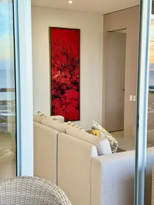 a row of couches in a room with a red painting at Luxury Apartment betwen Cartagena and Barranquilla in Juan de Acosta
