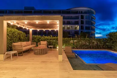 a swimming pool with a pergola next to a building at Deluxe en MorrosEos con piscina privada y salida a la playa in Cartagena de Indias