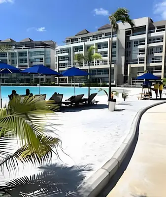 a pool with chairs and umbrellas in front of a building at Baia Kristal: descanso, vista y naturaleza única in Los Arrayanes