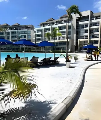 a pool at a resort with chairs and umbrellas at Baia Kristal: descanso, vista y naturaleza única in Los Arrayanes