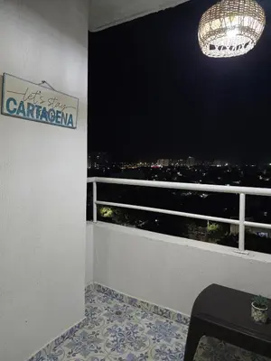 a room with a balcony with a chandelier at Apartamento Cerca al Mar Cartagena in Cartagena de Indias