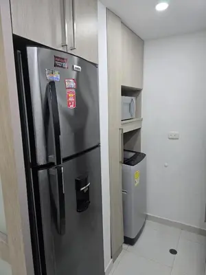 a kitchen with a stainless steel refrigerator in a room at Apartamento Cerca al Mar Cartagena in Cartagena de Indias