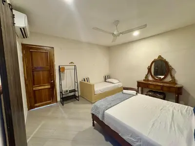 a bedroom with a bed and a mirror and a table at Casa Stephanie - Getsemani - Private pool in Cartagena de Indias