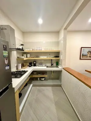 a kitchen with a counter and a stove in it at Casa Stephanie - Getsemani - Private pool in Cartagena de Indias