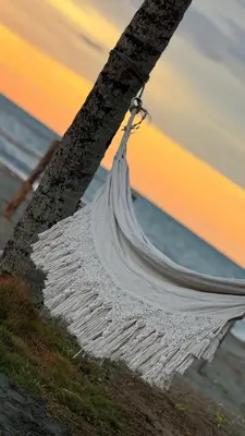 a white net hanging from a pole on the beach at Casa jaguar frente al mar in San Bernardo del Viento