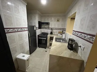a small kitchen with a sink and a stove at Apartamento Barrio San Jose Barranquilla in Barranquilla