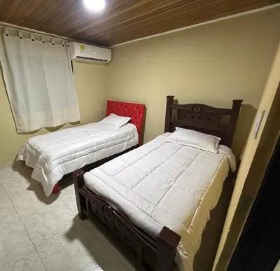 two beds in a small room with at Apartamento Barrio San Jose Barranquilla in Barranquilla