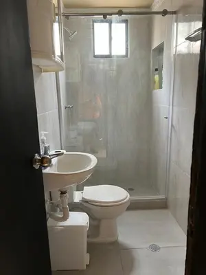a bathroom with a toilet and a sink and a shower at Apartamento Barrio San Jose Barranquilla in Barranquilla