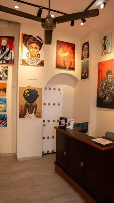 a room with many paintings on the walls at Art Hotel Getsemani in Cartagena de Indias