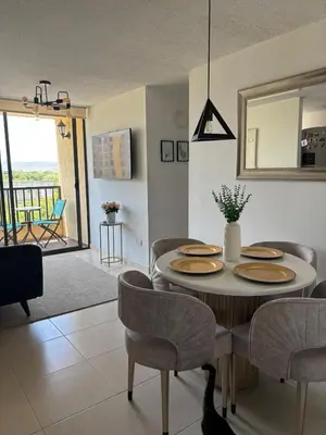a living room with a table and chairs and a dining room at Corazón de quilla in Barranquilla