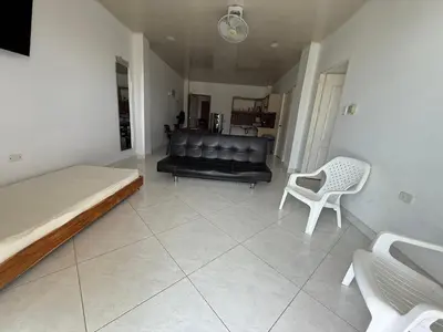 a living room with a couch and a chair at Apartment 402 Tolú 2 habitaciones in Tolú