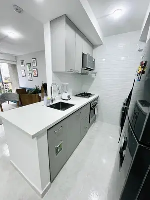 a white kitchen with a sink and a stove at Beach Nearby Stunning Views Ultimate Comfort in Cartagena de Indias