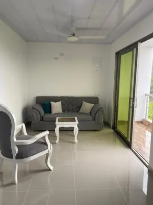 a living room with a couch and a table and a chair at MiraMar in Guayabal