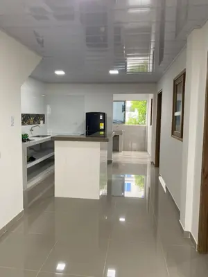 a large kitchen with white walls and a tile floor at MiraMar in Guayabal