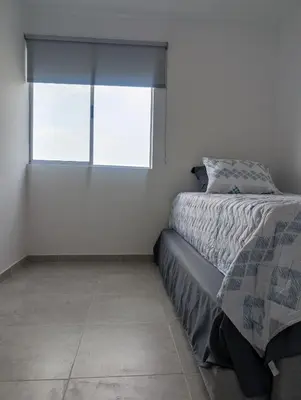 a bedroom with a bed and a window at Apartamento amoblado en Cartagena cerca a la playa in Cartagena de Indias