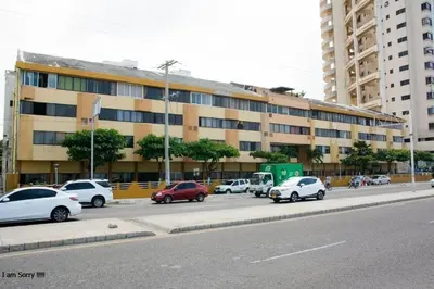 a parking lot with cars parked in front of a building at apartamento en marbella dúplex, cerca centro histórico - 3 in Cartagena de Indias
