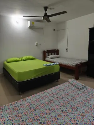 a bedroom with two beds and a ceiling at Las Margaritas Frente al Mar 1 in Coveñas