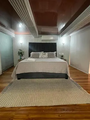 a large bed in a room with a wooden floor at Apartamento Cartagena - centro histórico in Cartagena de Indias