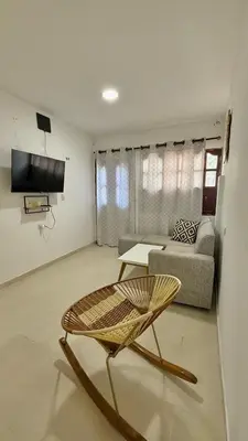 a living room with a chair and a couch at Boquilla Cozy Spot Live Like a Local in Cartagena de Indias