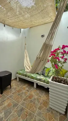 a hammock in a room with plants and flowers at Boquilla Cozy Spot Live Like a Local in Cartagena de Indias