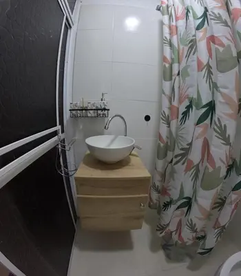 a bathroom with a sink and a shower curtain at Boquilla Cozy Spot Live Like a Local in Cartagena de Indias