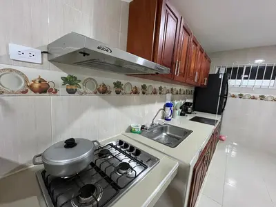 a kitchen with a stove top oven next to a sink at Casa Hotel Luisa in Cartagena de Indias
