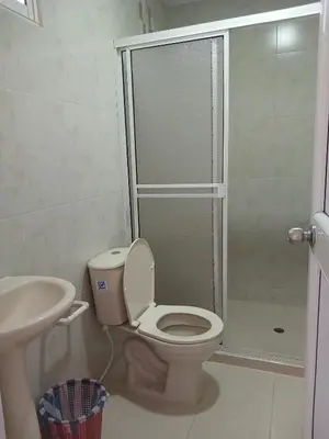 a bathroom with a toilet and a sink and a shower at Casa Hotel Luisa in Cartagena de Indias