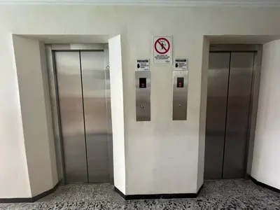 two metal elevators in a building with a no smoking sign at Laguito Beach Cartagena in Cartagena de Indias