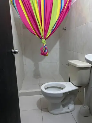 a bathroom with a toilet and a colorful shower curtain at Apartamento Goyo en Coveñas in Coveñas