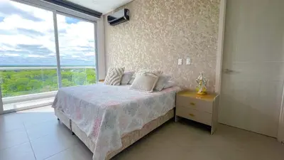 a bedroom with a bed and a large window at Magico Apartamento Frente al Mar 4 Habitaciones CB72 in Estación El Salto