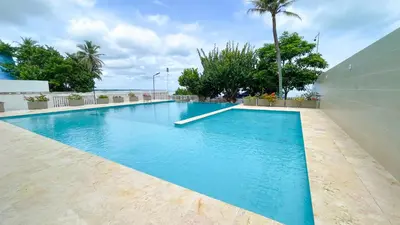 a large swimming pool with blue water in a building at Magico Apartamento Frente al Mar 4 Habitaciones CB72 in Estación El Salto