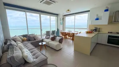 a kitchen and a living room with a couch and a table at Magico Apartamento Frente al Mar 4 Habitaciones CB72 in Estación El Salto