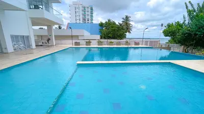 a large blue swimming pool in a building at Magico Apartamento Frente al Mar 4 Habitaciones CB72 in Estación El Salto