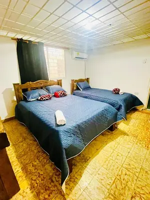 a bedroom with two beds with blue comforters at Lilis house in Cartagena de Indias