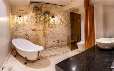 a bathroom with a bath tub and a sink at IsaLuna Luxury House in Cartagena de Indias