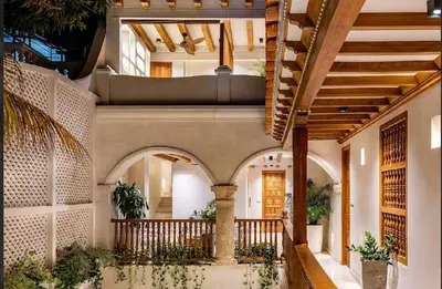 an indoor courtyard with a bed in a building at IsaLuna Luxury House in Cartagena de Indias